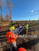 Large American flag being folded by a group of people