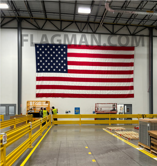 American flag in a warehouse for wall mounting with grommets along the edges.