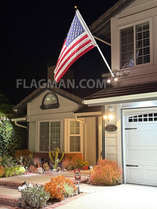 commercial aluminum flagpole off a home at night