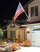 commercial aluminum flagpole off a home at night