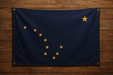 Realistic looking Alaska flag with brass grommets in all 4 corners mounted to a wood wall