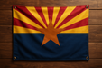 Realistic looking arizona flag with brass grommets in all 4 corners, mounted to a wood wall