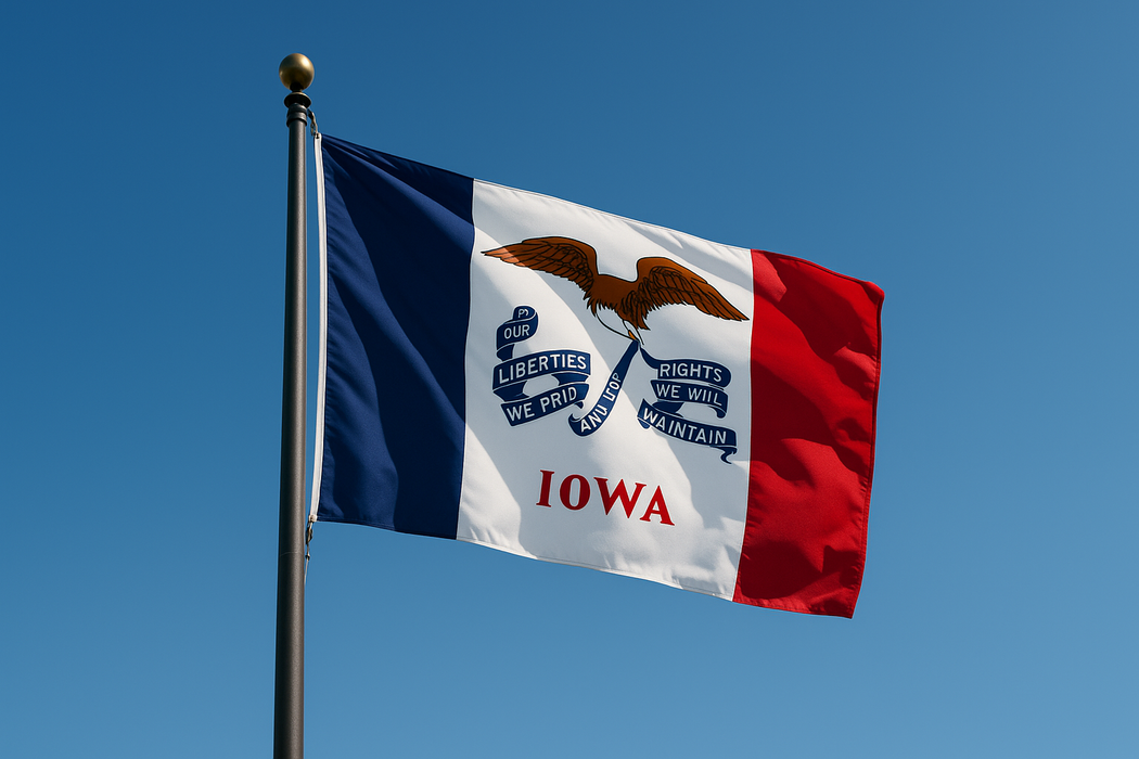 Realistic looking Iowa flag flying on a flagpole with clear blue sunny skies behind it