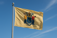 Realistic new jersey flag flying on a flagpole with clear blue sunny skies